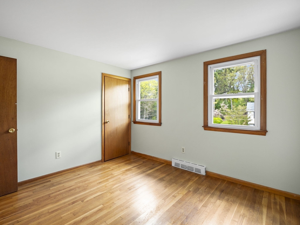 167 Karen Circle Holliston, MA 01746 - Photo 20 of 30 a view of an empty room with wooden floor and a window