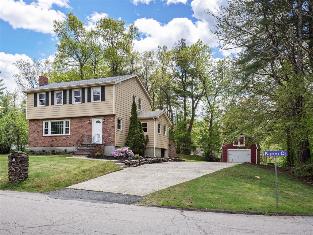 167 Karen Circle Holliston, MA 01746 - Photo 2 of 30 a front view of a house with a yard and trees