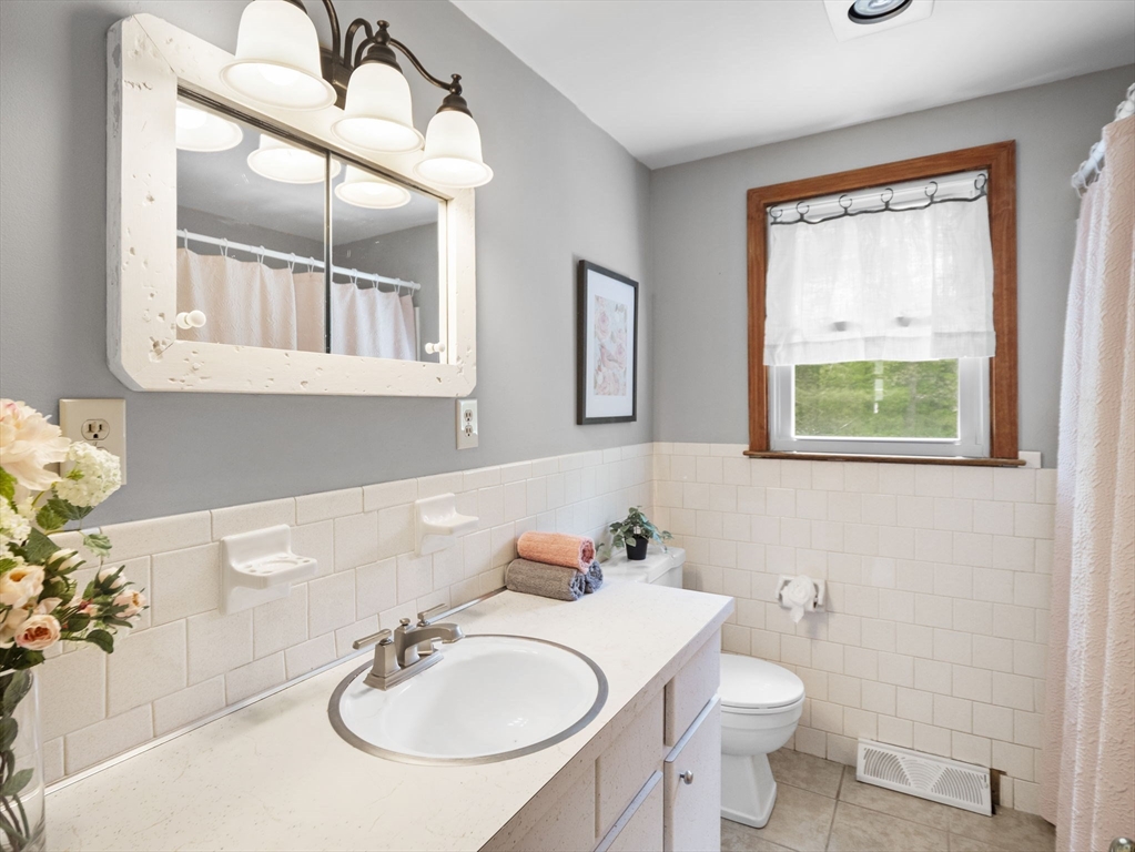 167 Karen Circle Holliston, MA 01746 - Photo 23 of 30 a bathroom with a sink vanity mirror and toilet
