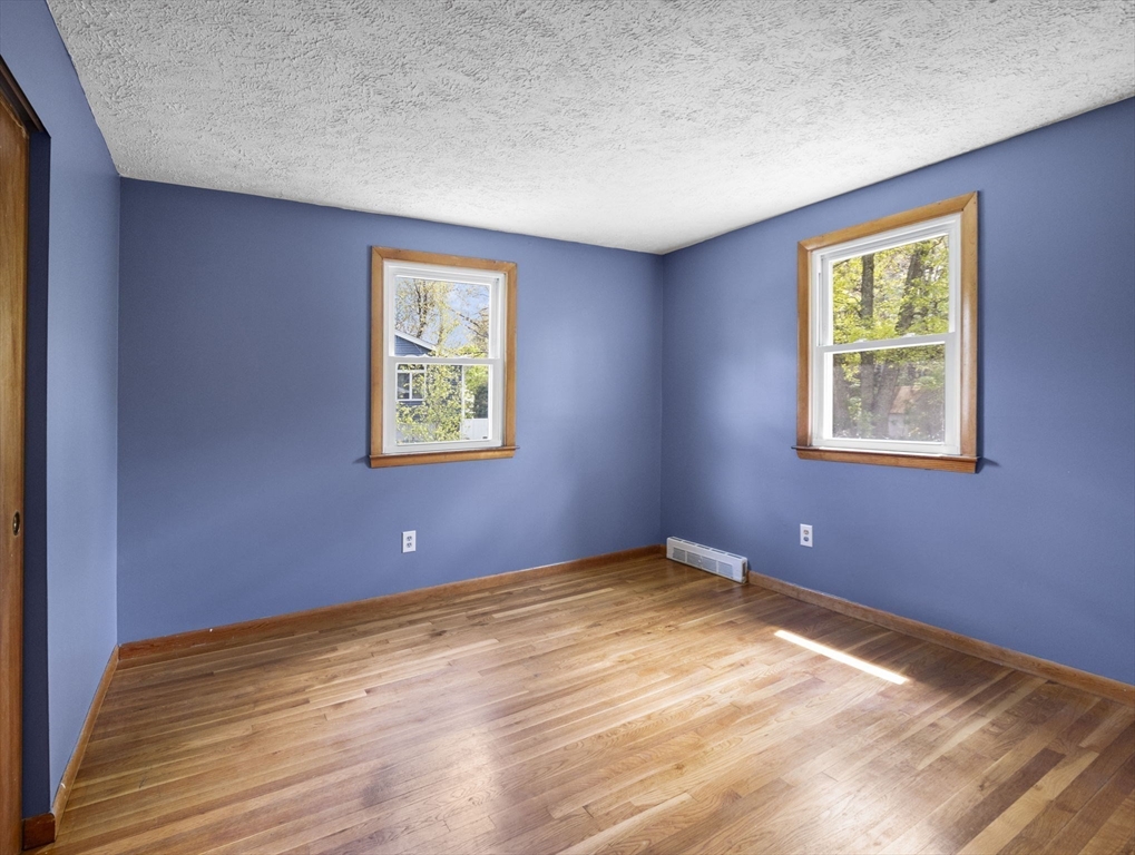 167 Karen Circle Holliston, MA 01746 - Photo 26 of 30 a view of a big room with wooden floor and windows