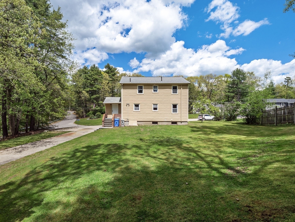 167 Karen Circle Holliston, MA 01746 - Photo 6 of 30 a view of a white house with a big yard and large trees