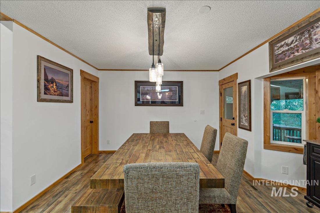 79 Sunset Loop Cascade, ID 83611 - Photo 15 of 44 Dining area featuring a prominent wood-finish dining table and matching wood-finish flooring