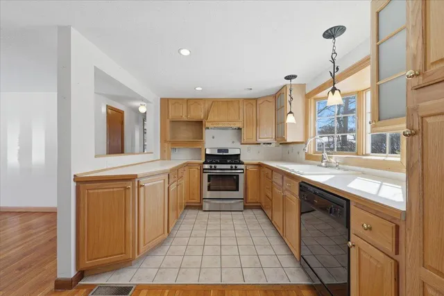 a kitchen with stainless steel appliances granite countertop a stove and a sink