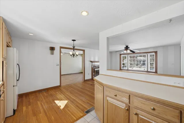 a view of a kitchen with a sink and refrigerator