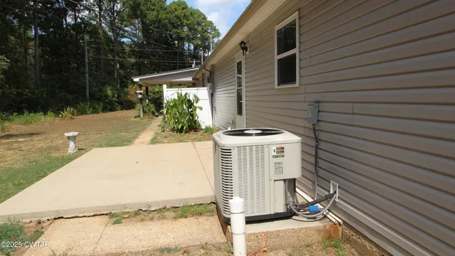 a view of a patio with table and chairs with wooden fence and plants