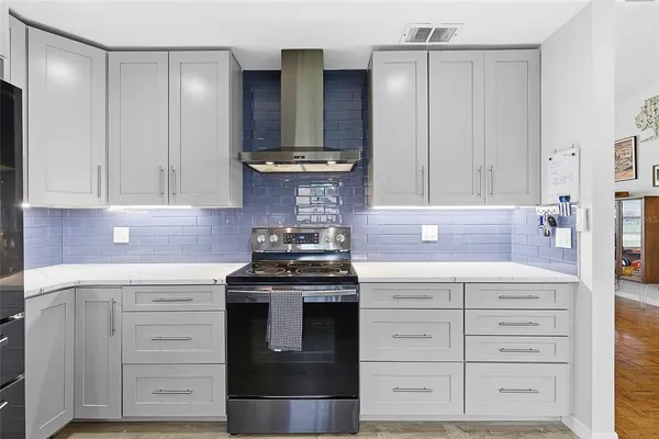 a stove top oven sitting inside of a kitchen