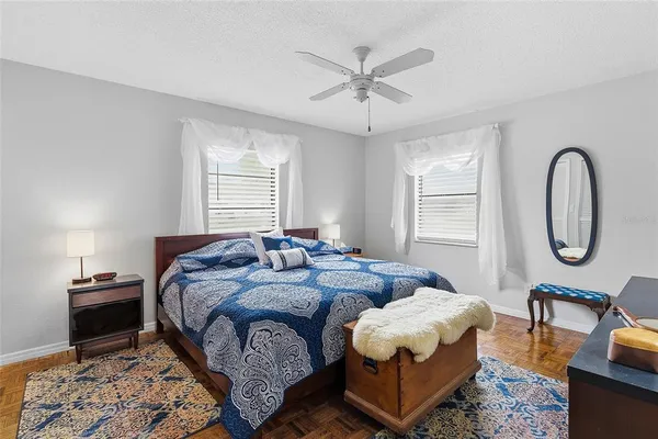 a spacious bedroom with bed and a window