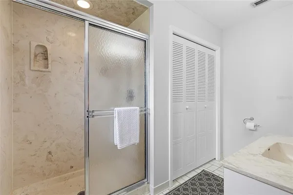a bathroom with a shower and a sink