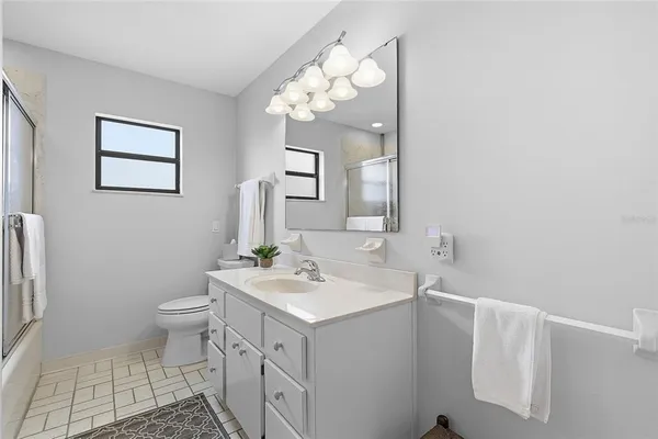 a bathroom with a sink a toilet and mirror