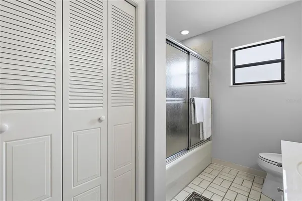 a bathroom with a glass shower door and a toilet