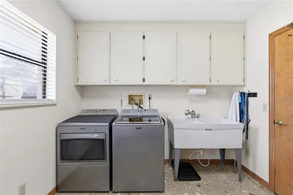 a utility room with sink dryer and washer