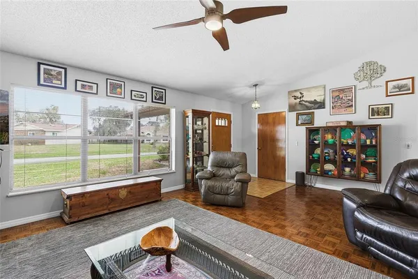 a living room with furniture and a floor to ceiling window
