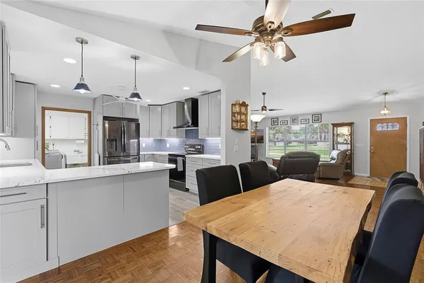 a large kitchen with a table and chairs