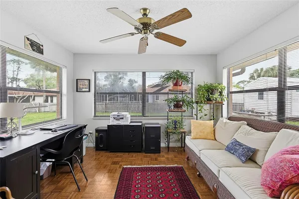 a living room with furniture a large window with wooden floor