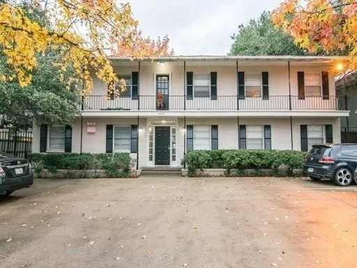 a front view of a brick house with a yard