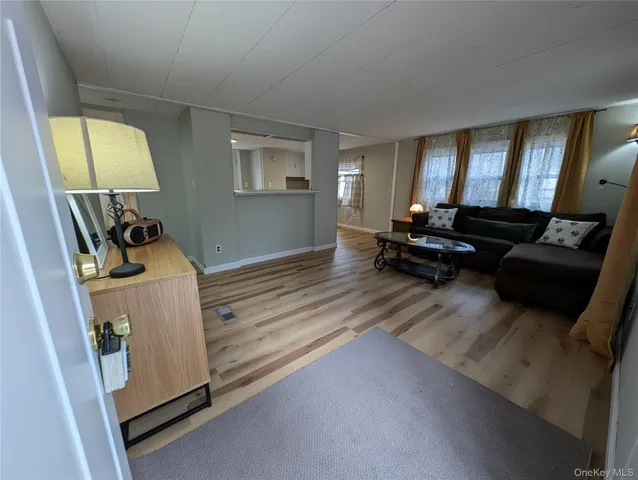 a spacious bedroom with a bed and a mirror