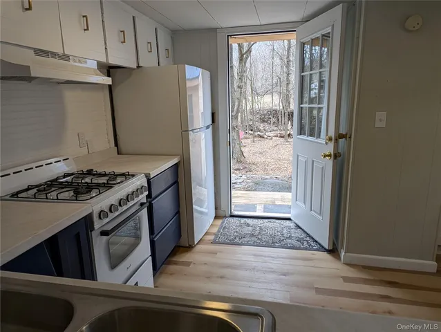 a kitchen with a stove and a refrigerator