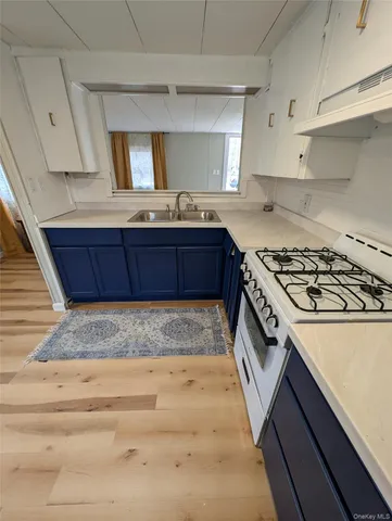 a kitchen with granite countertop a stove and a sink