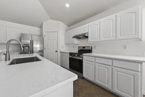 a kitchen with cabinets and stainless steel appliances