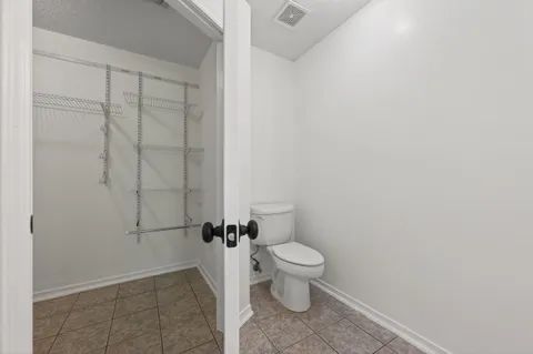a bathroom with a double vanity sink toilet mirror and shower