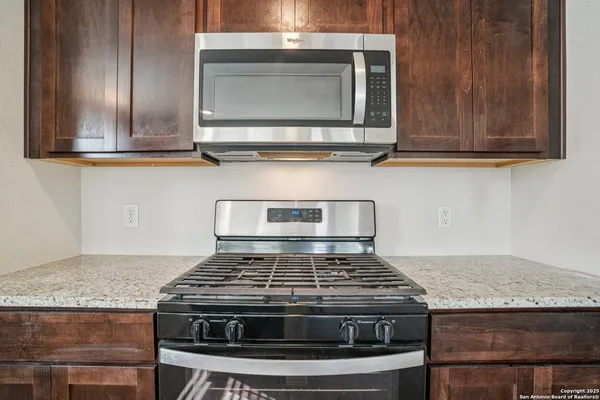 a stove top oven sitting inside of a kitchen