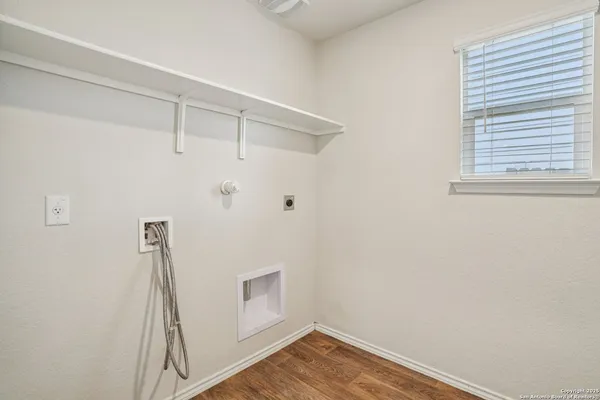a view of small space with wooden floor and white wall