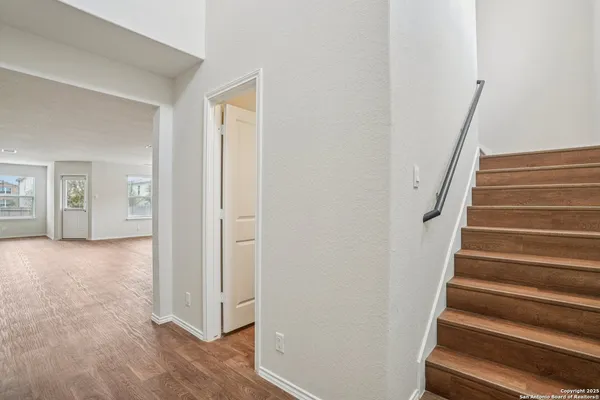 a view of a hallway with wooden floor and entryway