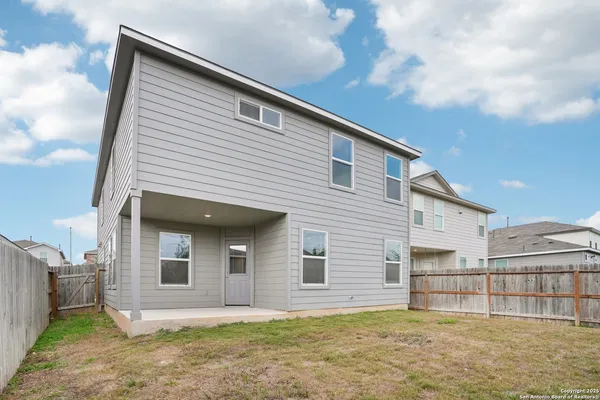 a view of a house with a backyard and balcony