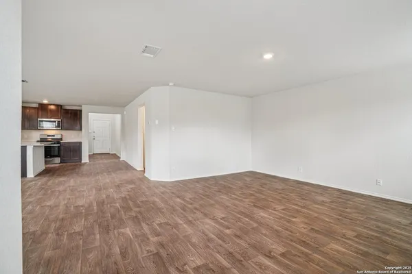 a view of a kitchen with wooden floor and a kitchen