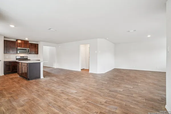 a view of kitchen with kitchen island microwave and stove