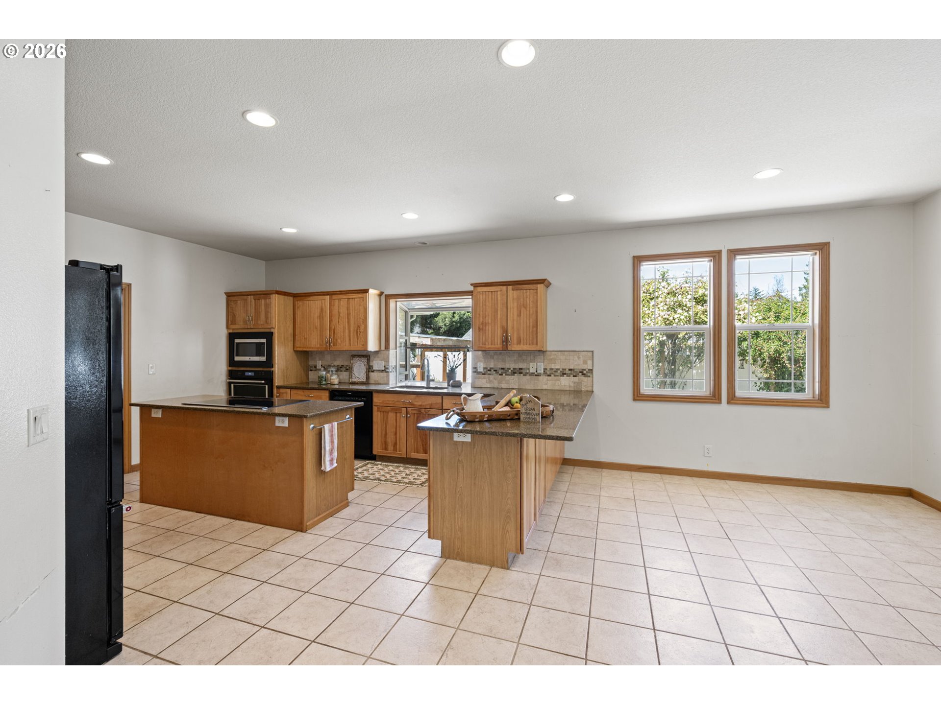 2218 Willow Loop Florence, OR 97439 - Photo 23 of 47 a kitchen with a refrigerator and a stove top oven