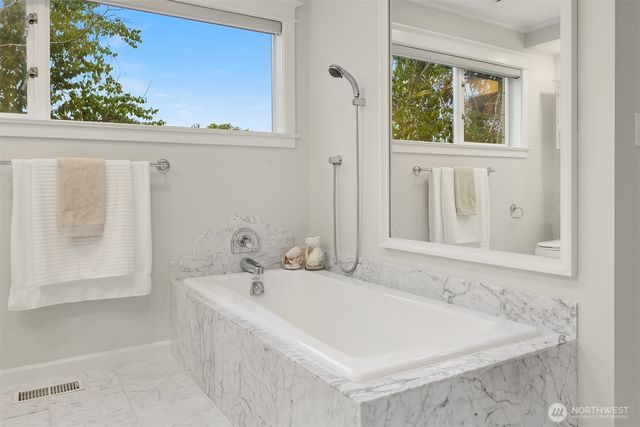 a white bath tub sitting next to a white sink