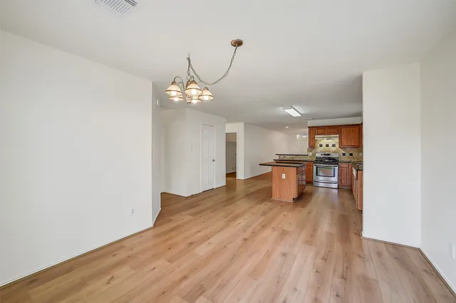 a view of a kitchen with a sink and wooden floor