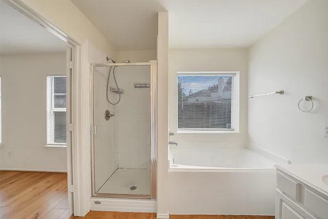 a bathroom with a tub shower and sink