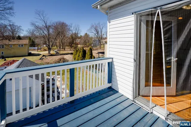 a view of balcony with wooden floor and fence