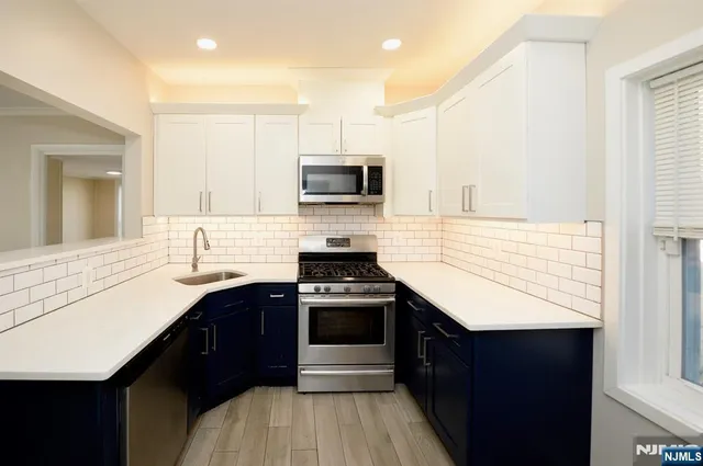 a kitchen with a sink stove and microwave
