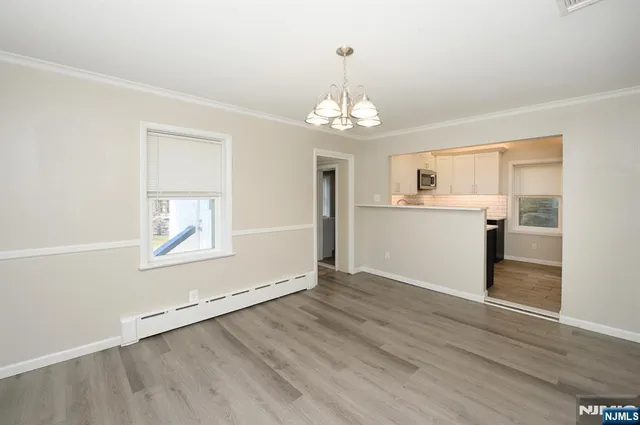 a view of a kitchen with wooden floor and a kitchen