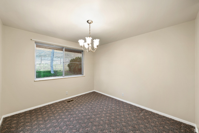 1940 West Old Hwy Road Morgan, UT 84050 - Photo 27 of 73 Interior room featuring a patterned carpet, neutral wall paint, and a window offering natural light