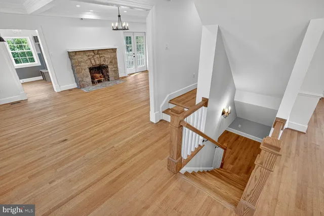 wooden floor view with staircase and fireplace