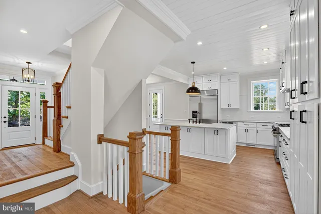 a kitchen with white cabinets and sink