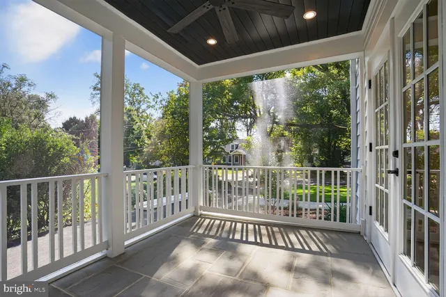 a view of a porch with wooden floor in front of a house