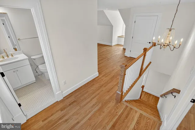a view of a room with wooden floor and staircase