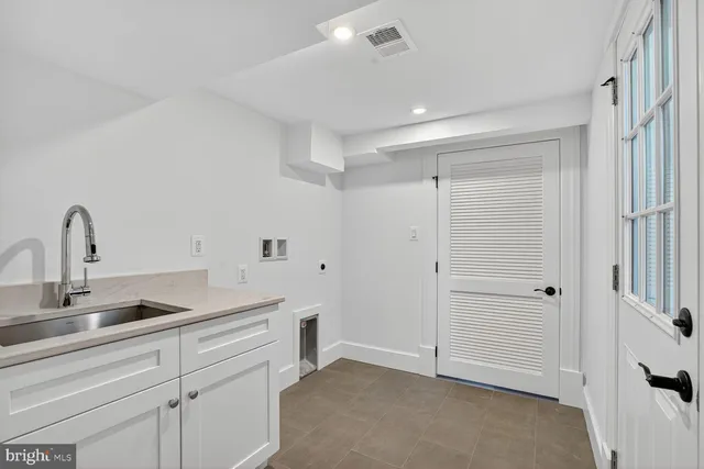 a kitchen with a sink and cabinets