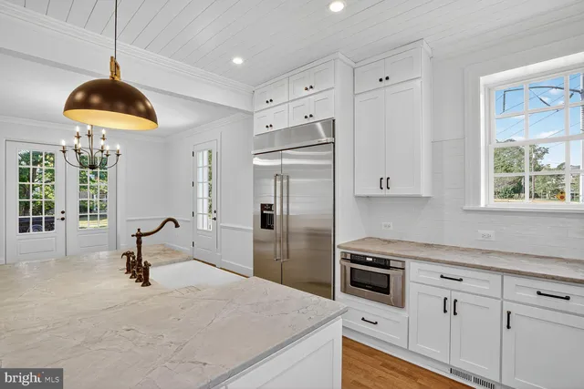 a kitchen with stainless steel appliances a stove a refrigerator and a sink