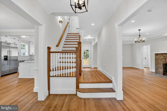 a view of an entryway with wooden floor and staircase