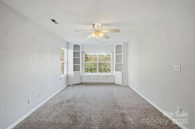 a view of room with window and ceiling fan