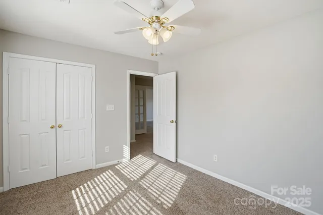 a view of a bedroom with a chandelier fan
