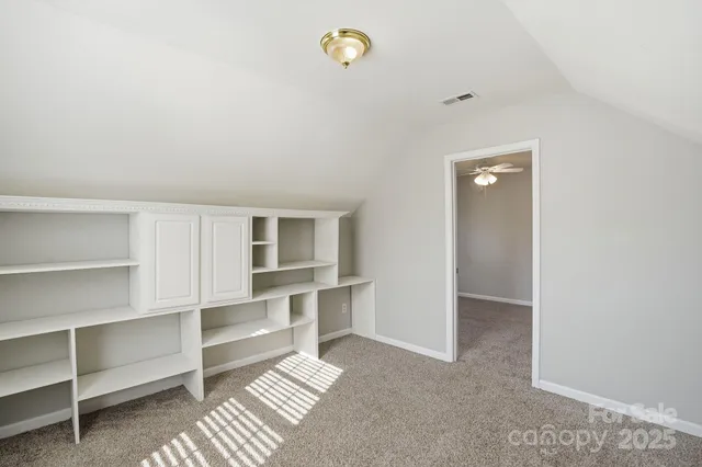 a view of workspace with wooden floor and cabinet