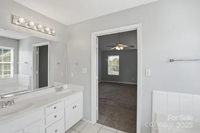 a bathroom with a granite countertop sink a mirror and a vanity