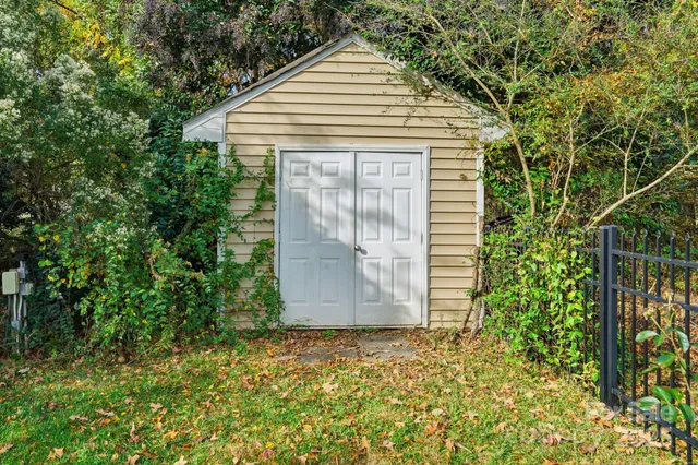 a view of a house with a backyard and a tree